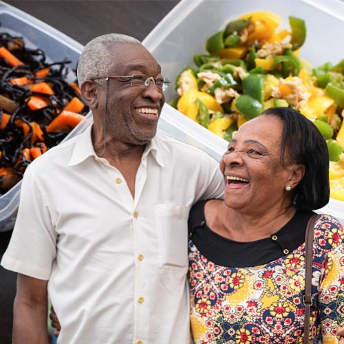 An older couple in front of food